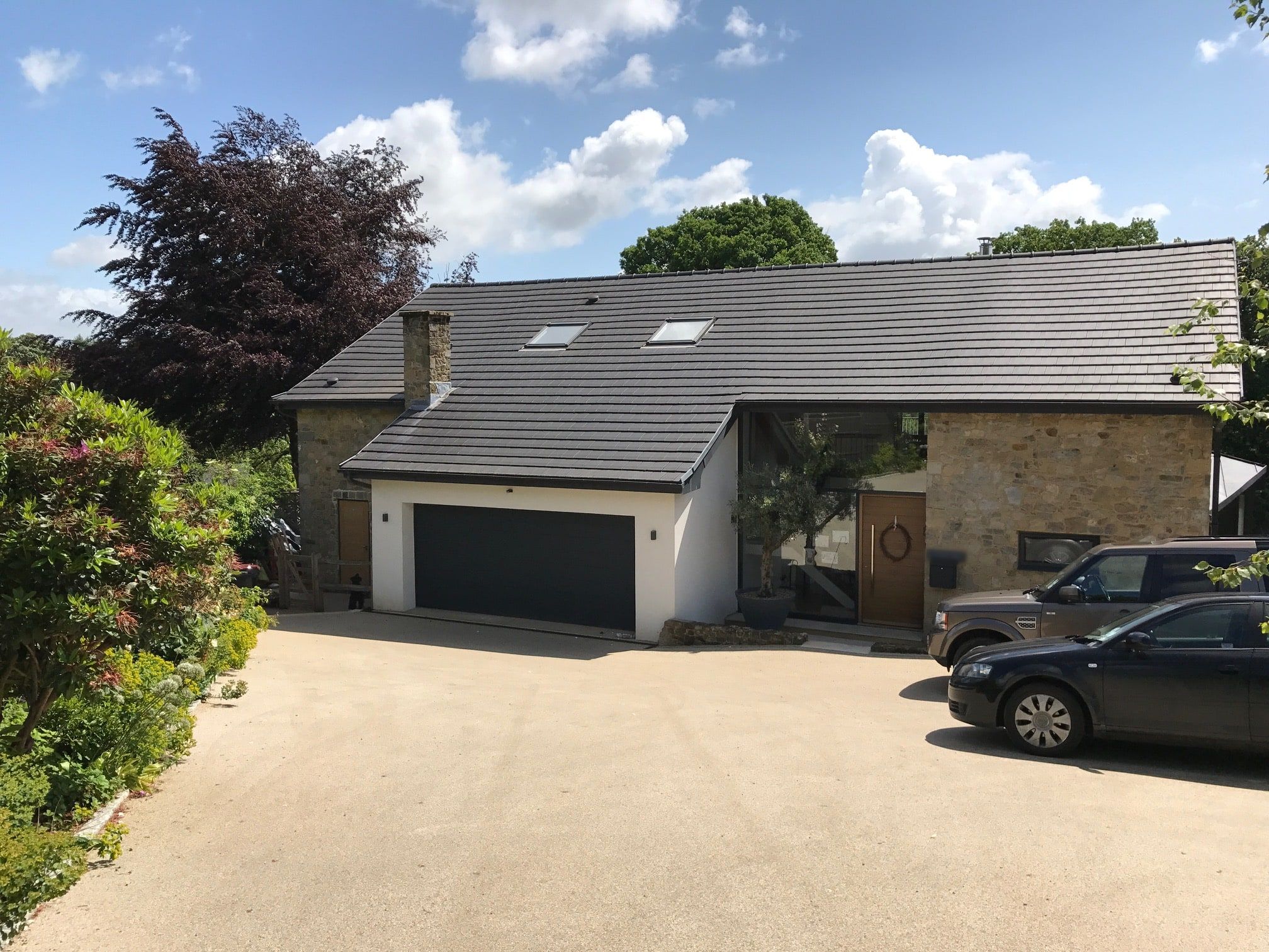 Gravel drive and garage wing under the new grey clay tile roof, 1960s house, Lodsworth.