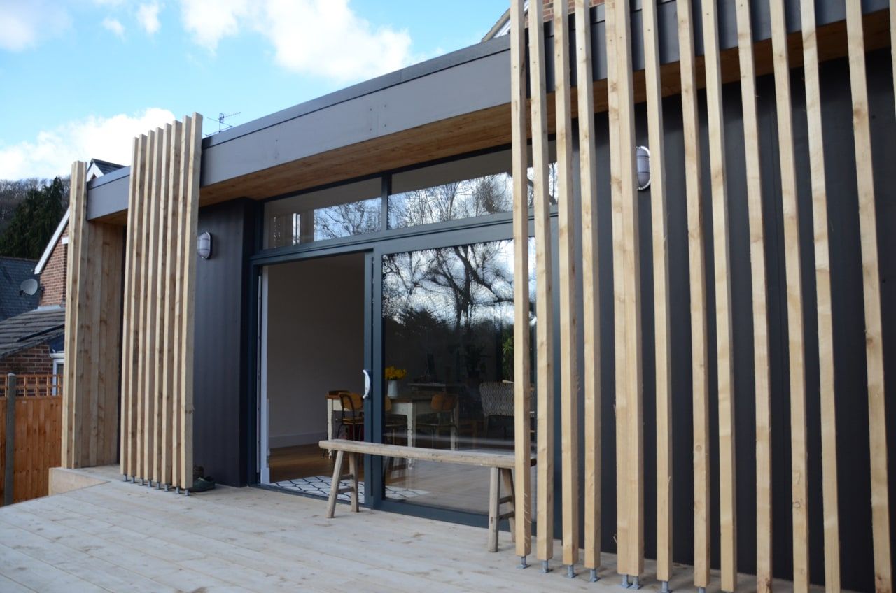 Sliding doors open from the open-plan living space onto the terrace, period house, Haslemere.