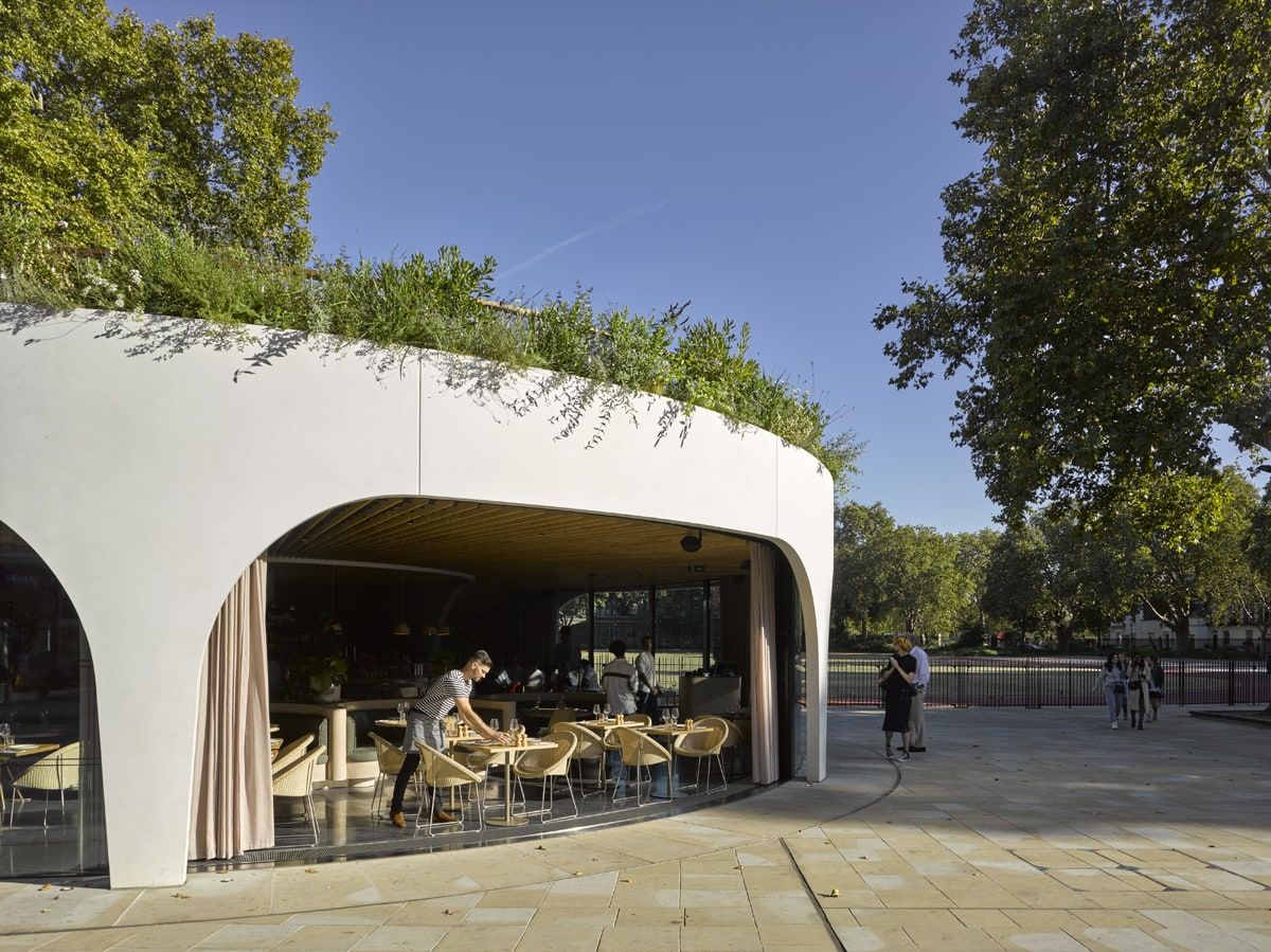 Facade fully retracted into the basement, the arch open to the paving, restaurant pavilion, Duke of York Square, London.