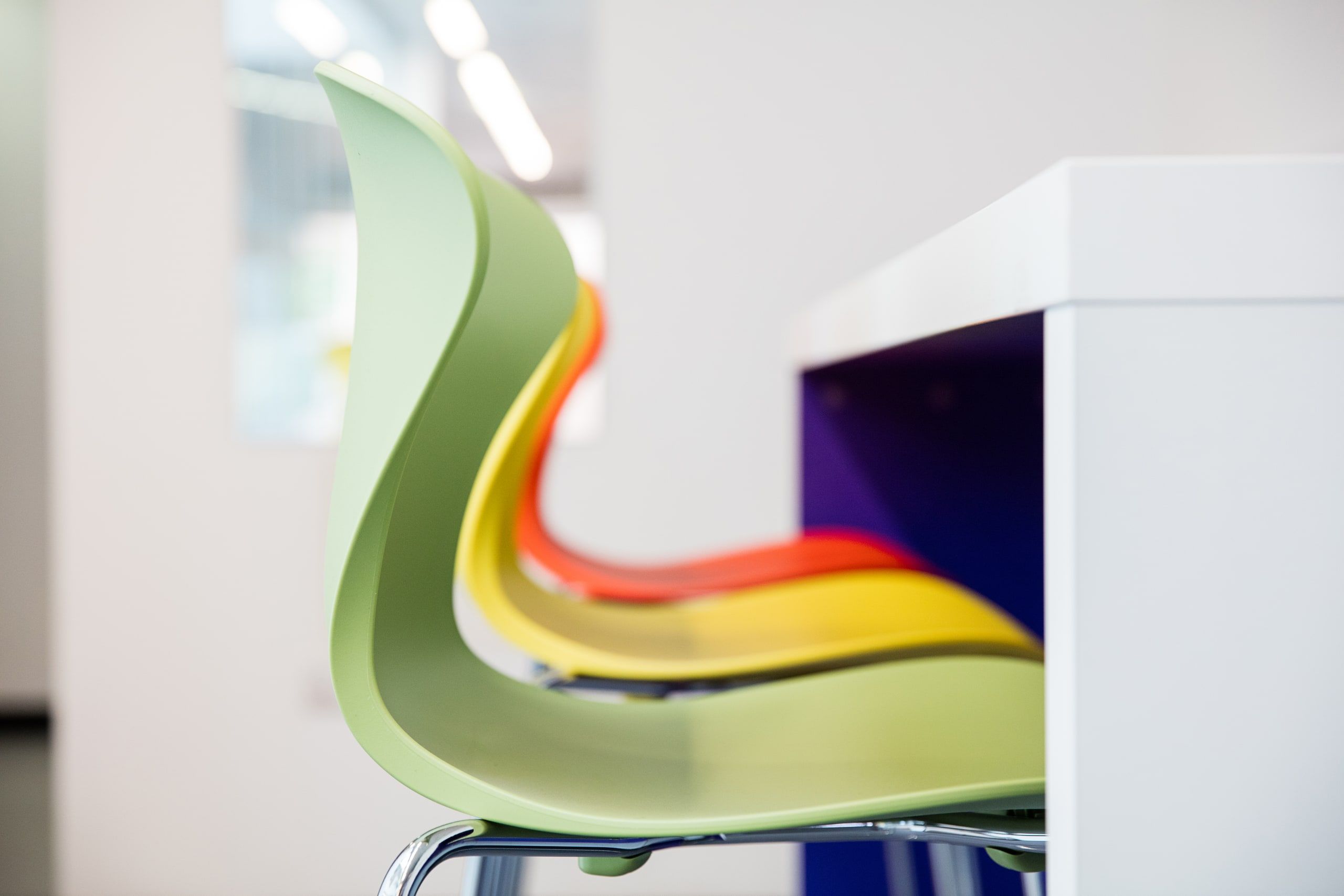 Close view of the layered green, yellow and red backs of the new seating, 6th Form Centre, Newbury.