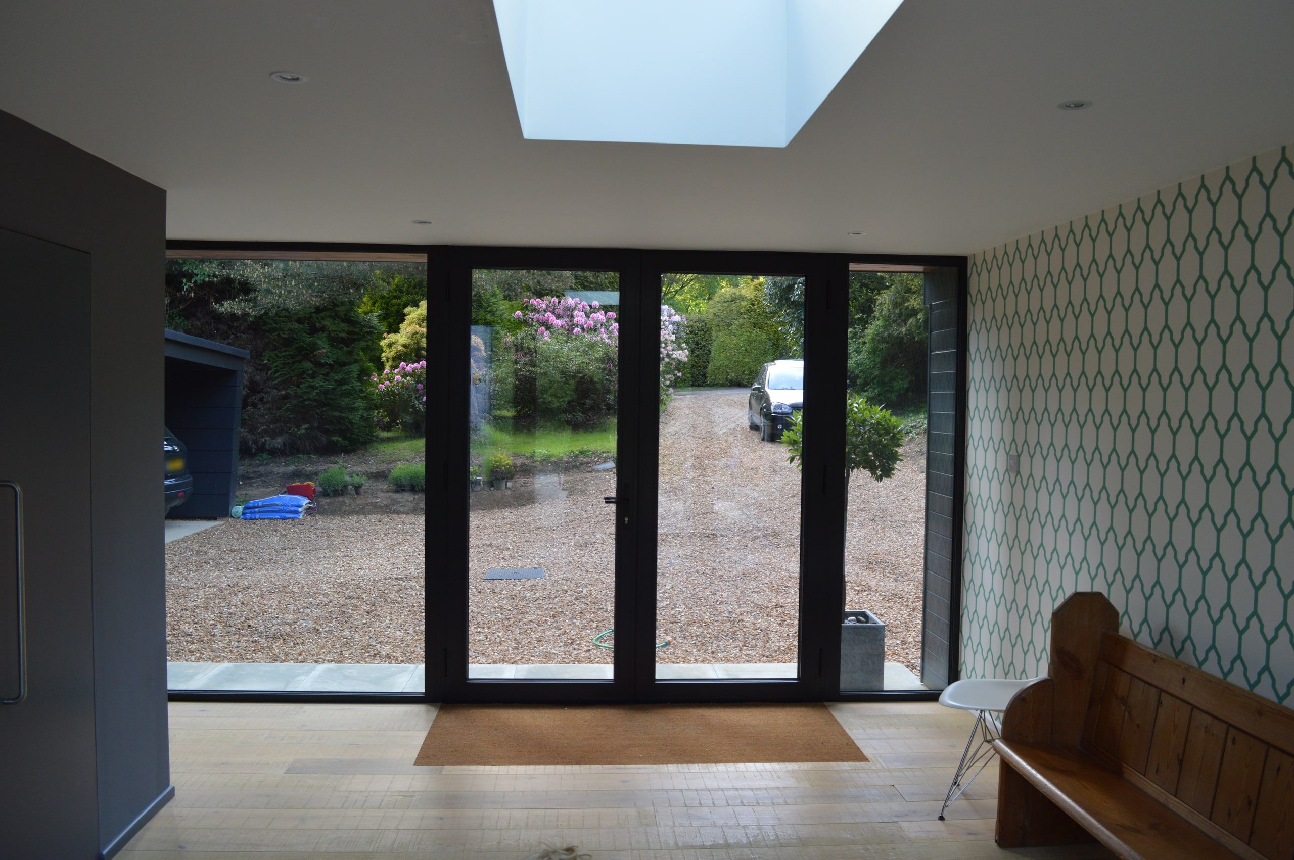 Rooflight over the entrance hall, glazed doors opening onto the gravel drive, 1960s house, Haslemere.