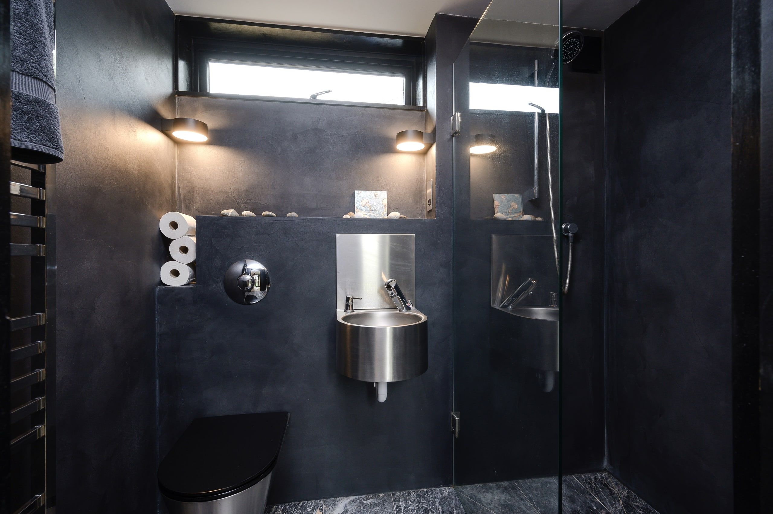 Black polished-plaster shower room with a stainless steel basin, 1960s house, Fernhurst.