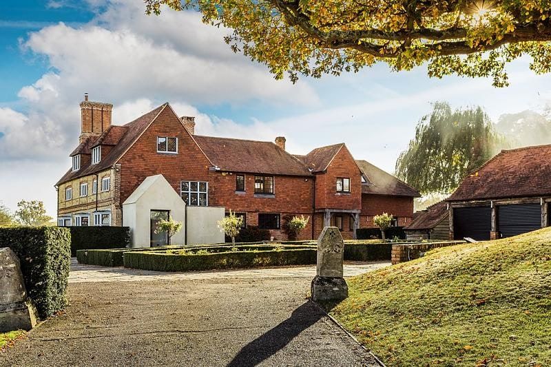 Gravel approach to the sandstone-clad entrance and cloakroom extension, listed country house, Chiddingfold.