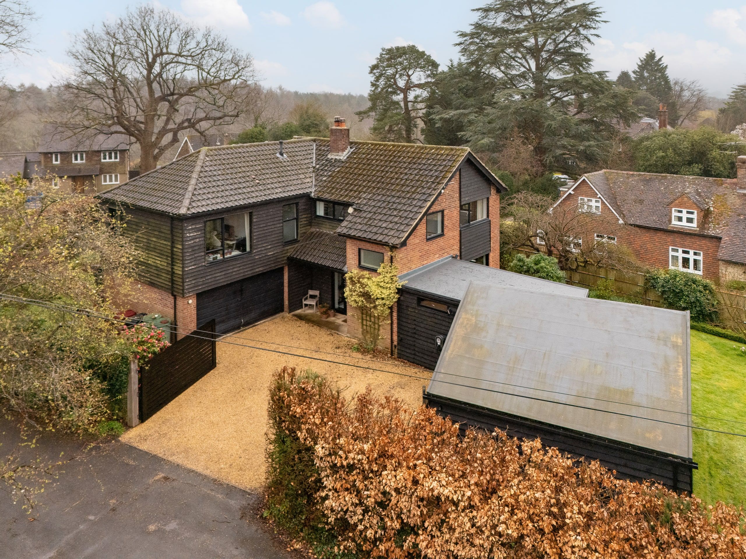 Aerial view of the gravel drive and garage wing seen from the lane, 1960s house, Fernhurst.