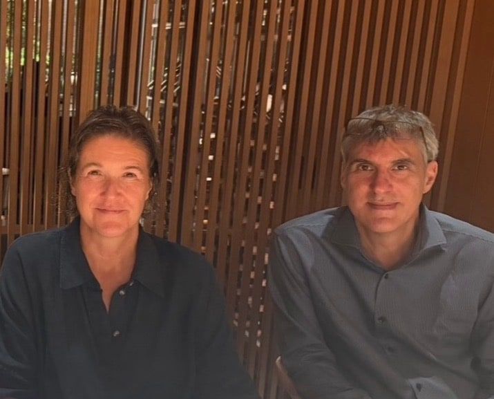 Irene Konschill and Jonathan Gratton of ArchitectureLIVE, seated outdoors against a timber slatted screen.